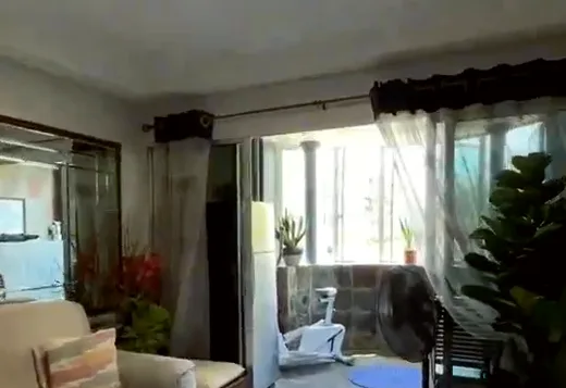 Living room with cream sofas and sheer curtains